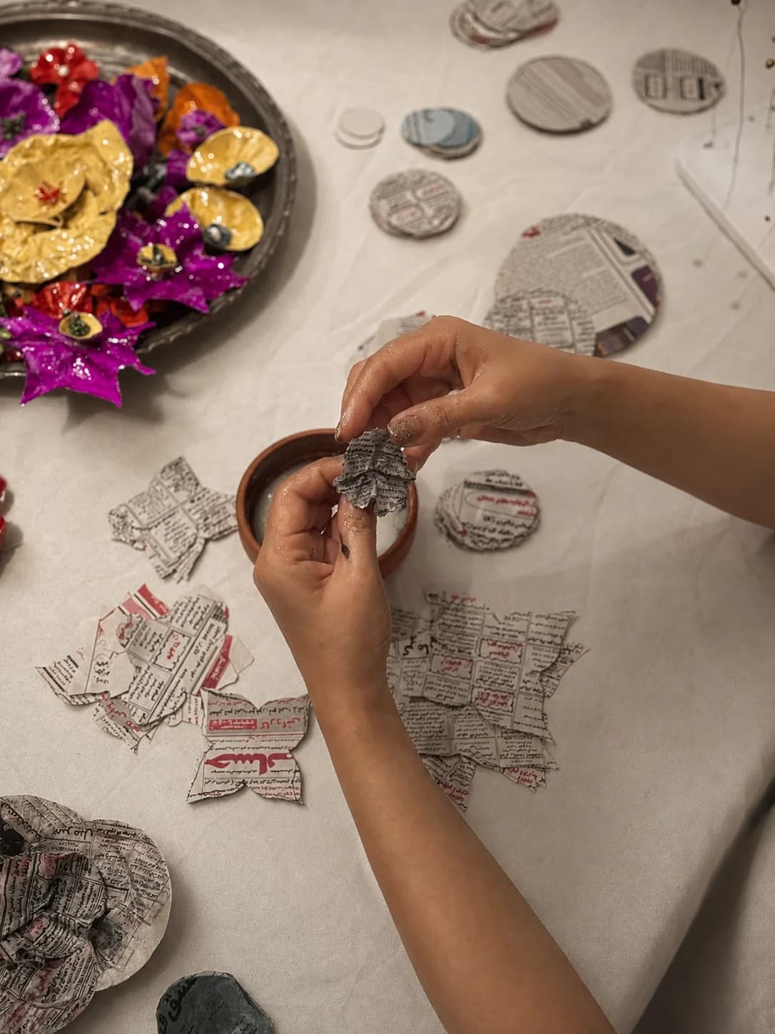 Handmade paper jewelry being layered and textured — Sara Idee process