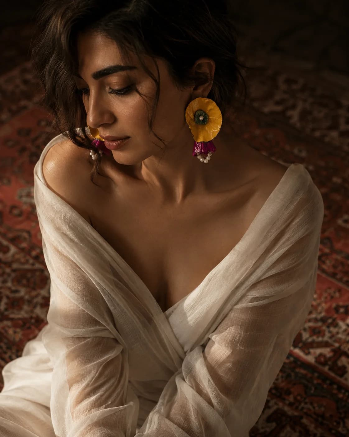 Handmade paper earring in a cinematic editorial portrait — Sara Idee wearable art