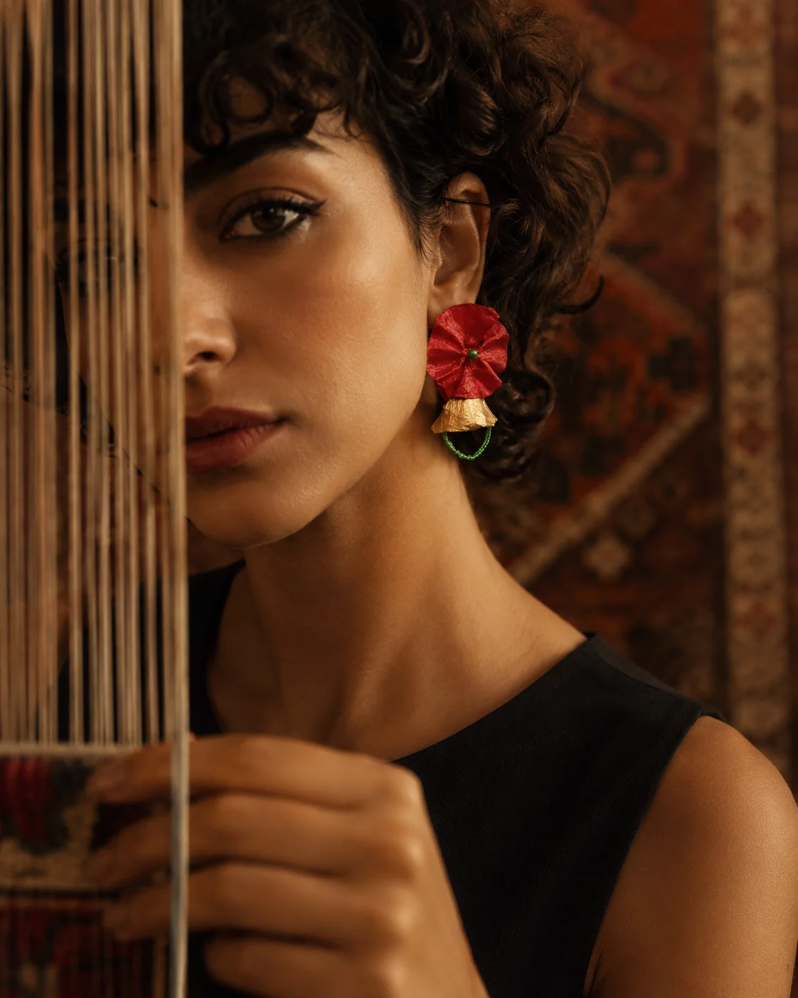 Sculptural paper earring worn close-up — handmade from recycled newspaper by Sara Idee